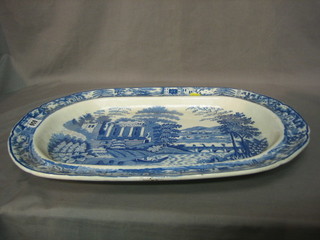 A 19th Century blue and white oval patterned meat plate decorated a ruined building 20"
