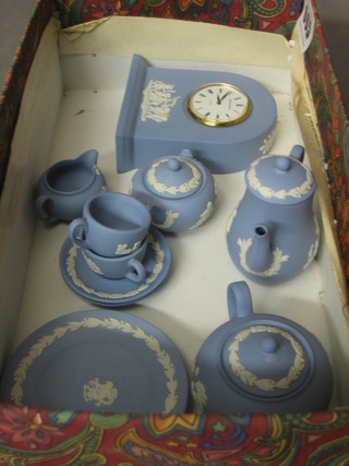 A Wedgwood arch shaped blue Jasperware mantel clock 3", a miniature coffee pot, miniature teapot, sugar bowl, cream jug,  2 cups and saucers and 2 plates