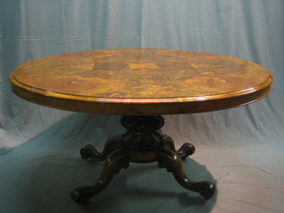 A Victorian oval snap top Loo table, raised on a carved column and tripod base (complete with bolts), 55"