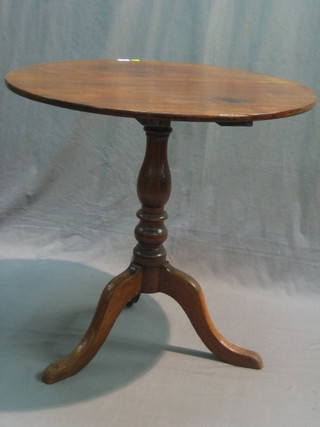 A 19th Century circular mahogany snap top tea table, raised on pillar and tripod supports 29"