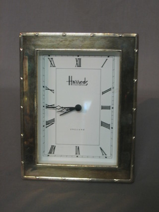 A Quartz table clock by Harrods contained in a silver case 7"