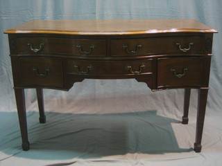 A  Georgian style mahogany sideboard of serpentine outline, fitted 2 long drawers above 3 short drawers, raised on square tapering supports ending in spade feet 48"