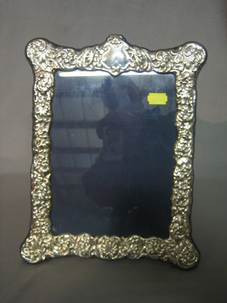 A modern embossed silver easel photograph frame 11" x 9"