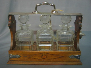 An oak and silver plated 3 bottle tantalus