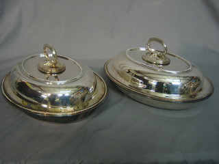 A pair of oval silver plated entree dishes with bead work borders