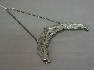 A pierced white metal hand bag frame