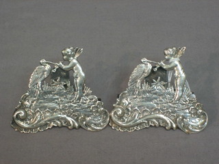 A pair of Continental silver menu holders decorated stork with cherub