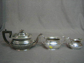 An oval Georgian style Britannia metal 3 piece tea service comprising teapot, twin handled sugar bowl and milk jug with demi-reeded decoration