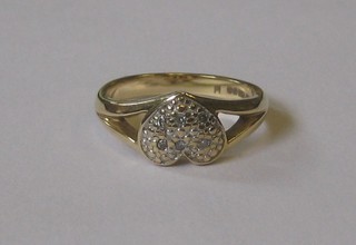 A lady's 9ct gold dress ring in the form of a heart set diamonds