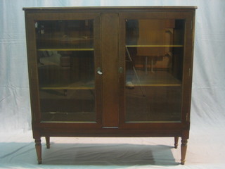 A mahogany display cabinet, the interior fitted adjustable shelves enclosed by glazed panelled doors 43"