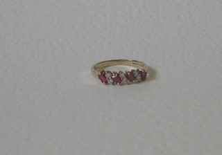 A lady's gold dress ring set 4 baguette cut rubies supported by 6 small diamonds