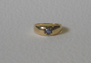 An 18ct gold gypsy style dress ring set a sapphire