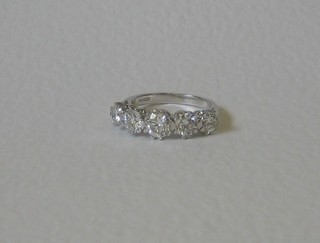 A lady's attractive 18ct white gold dress/engagement ring set 5 diamonds (the diamonds have been treated for clarity)