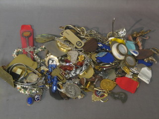 A collection of costume jewellery, cap badges etc 