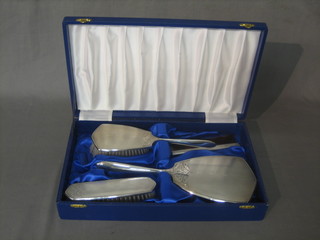 A modern 4 piece silver backed dressing table set with hair brush, clothes brush, hand mirror and comb