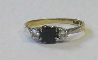 An 18ct gold dress ring set a rectangular cut sapphire supported by 2 diamonds