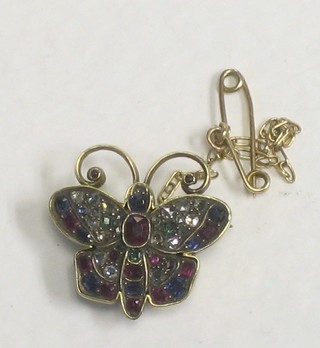 A gilt metal brooch in the form of a butterfly set semi-precious stones