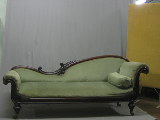 An early Victorian mahogany show frame sofa upholstered in green material, raised on turned supports 82"