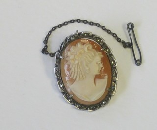 A shell carved cameo portrait brooch contained in a marcasite brooch mount