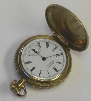A lady's Waltham fob watch contained in a gold plated and engraved case