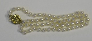 A rope of cultured pearls with 9ct gold clasp