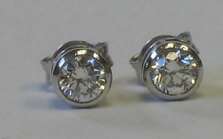 A pair of solitaire diamond ear studs approx 0.65ct