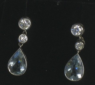A pair of circular diamond earrings hung tear drop aquamarine, surmounted by 2 diamonds