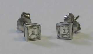 A pair of square diamond ear studs, approx 0.90ct