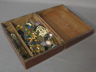A collection various costume jewellery contained in a wooden trinket box