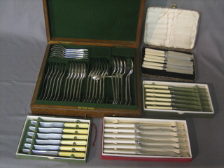 A canteen of silver plated flatware contained in an oak canteen box, 2 sets of 6 tea knives and 2 sets of 6 table knives