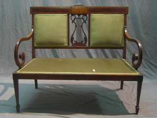 An Edwardian inlaid mahogany double chair back settee raised on square tapering supports ending in spade feet 39"