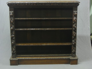 A Victorian carved oak bookcase, the interior fitted adjustable shelves, heavily carved throughout, 48"