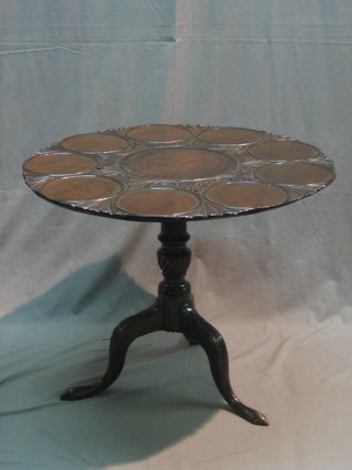 A Georgian mahogany circular snap top supper table, raised on pillar and tripod supports 29"