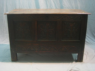 An 18th Century carved oak "mule" chest with hinged lid, heavily carved to the front 48"