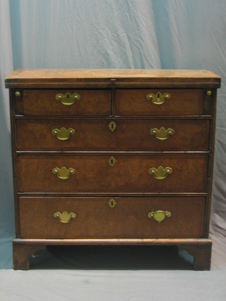 An 18th Century oak Bachelor's chest, later veneered in walnut, fitted 2 short and 3 long drawers with brass swan neck handles, raised on bracket feet 32"