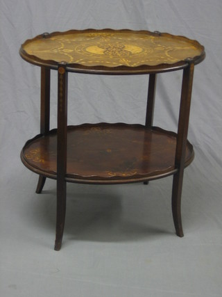 An Edwardian  mahogany oval 2 tier etagere, inlaid swag decoration and raised on spade feet 26"