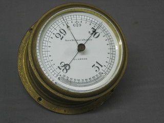 An aneroid barometer by Kelvin Bottomley & Baird of Glasgow with enamelled dial, contained in a gilt metal case 7"