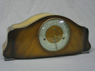 A 1950's Art Deco 8 day chiming mantel clock with Arabic numerals contained in an arched mahogany case
