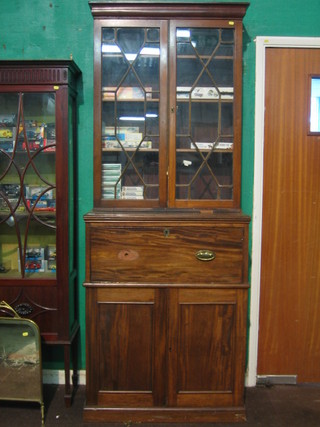 A  19th Century mahogany secretaire bookcase the upper section with moulded cornice fitted adjustable shelves enclosed by astragal glazed panelled doors, the base fitted a secretaire drawer above a double cupboard, raised on a platform base 32"