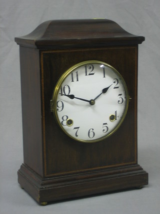 An Edwardian striking mantel clock with 5" circular dial and Roman numerals contained in an inlaid mahogany case