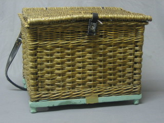 A rectangular basket work fishing box containing floats etc