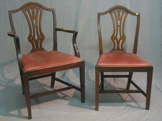 A set of 4 19th Century mahogany Hepplewhite, camel back style dining chairs with pierced vase shaped slat backs and upholstered seats, raised on square supports, 1 carver, 3 standard