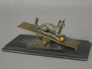 A 19th Century Austrian bronze cold painted paper clip in the form of a see saw with seated cat and ball 6"