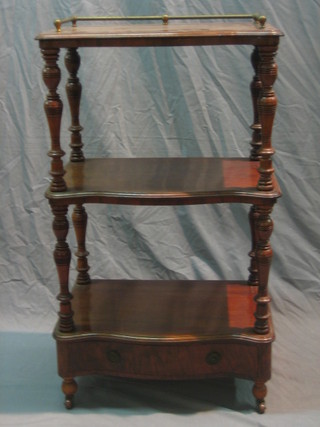 A Victorian 3 tier mahogany what-not of serpentine outline with brass three-quarter gallery, the base fitted a drawer 22"