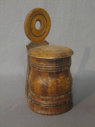 A circular wooden hanging salt box