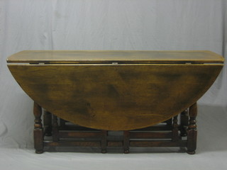 A large oak oval drop flap double gateleg dining table 66"
