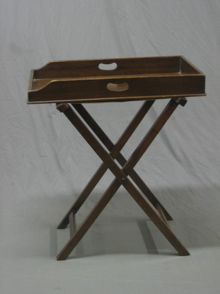 A Victorian rectangular mahogany Butler's tray raised on a folding stand 28"