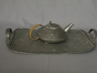 An Art Nouveau English pewter teapot, the base marked English pewter 0231 (some dents) together with an Art Nouveau planished English pewter twin handled tea tray, base marked 143 19" (misshapen)