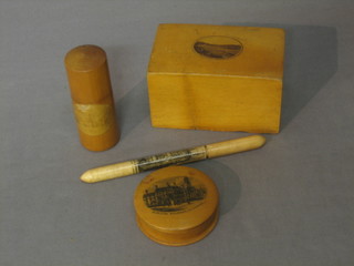 A Mocklin ware money box, a circular jar, a cylindrical jar and a needle case (4)