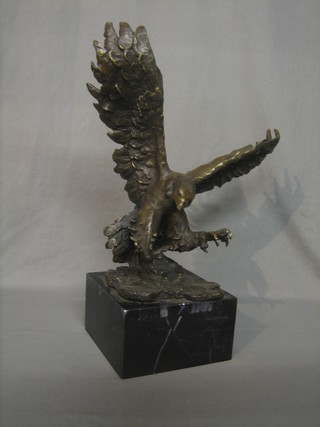 A reproduction bronze figure of an eagle with outstretched wings, raised on a square marble base 20" 